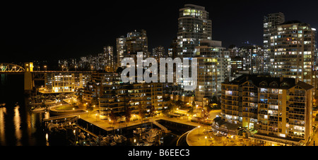 Davie Village Vancouver condomini di notte con False Creek Yacht Club e Burrard Street Bridge Foto Stock