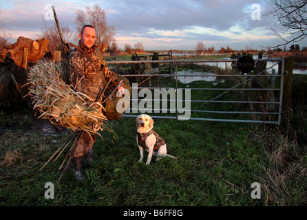 Un wildfowler e il suo cane andando le riprese Foto Stock