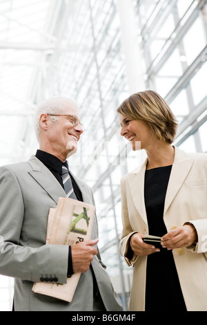 Vecchio Uomo che parla al più giovane donna Foto Stock