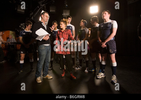 Il cantante Laura McGhee e membri di Glasgow Academy di rugby la registrazione delle loro linee di Rabbie Burns canzone Auld Lang Syne. Foto Stock