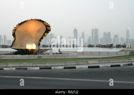 Oyster pearl scultura e fontana di acqua con waterfront skyline della città, Corniche, Doha, Qatar, Medio Oriente Foto Stock