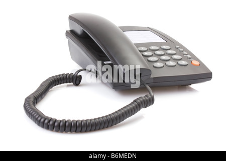 Telefono ufficio con cavo sinuose isolato su bianco. Foto Stock