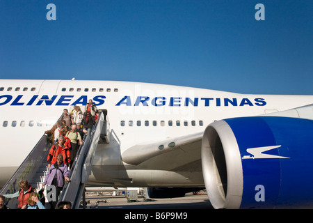 Passeggeri sbarcare un Aerolíneas Argentinas Boeing 747 jumbo jet aereo aereo in estate sole Buenos Aires Foto Stock