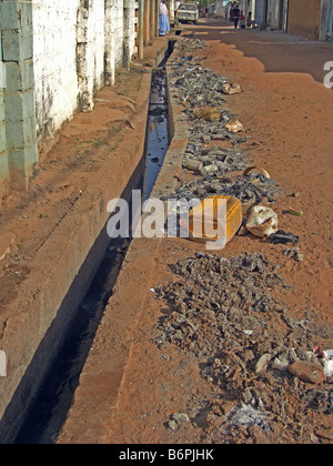 Acque reflue da scarichi aperto tra i vicoli di Bakau, in Gambia Africa Occidentale. Foto Stock