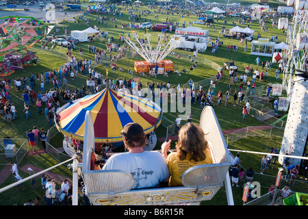 Un giovane gode la ruota panoramica Ferris a un piccolo carnevale di Monroe Connecticut USA durante l'estate Foto Stock