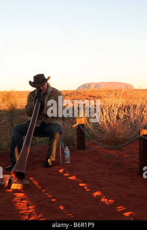 Didgeridoo Riproduzione di Uluru - Ayers Rock [Docker River Road, Uluru-Kata Tjuta National Park, il Territorio del Nord, l'Australia, Oceania Foto Stock