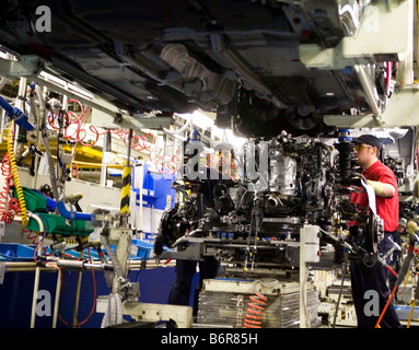 I lavoratori in casa Toyota il montaggio finale della linea di produzione preparazione del motore per il montaggio sul telaio di un Toyota Avensis auto Foto Stock