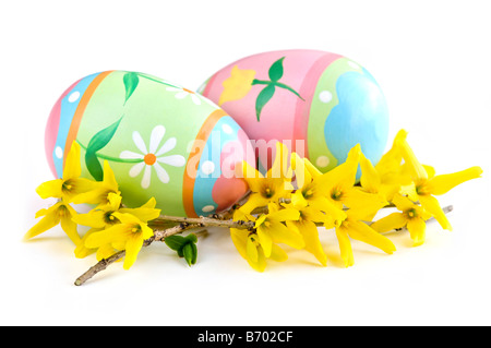 Uova di Pasqua in accordo con fiori di primavera isolato su sfondo bianco Foto Stock