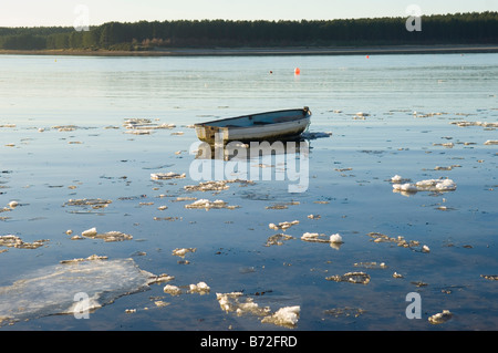 Barca a remi su una baia di Findhorn coperta di ghiaccio Foto Stock