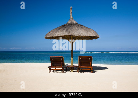 Spiaggia di Mauritius con vista sull Oceano Indiano con due lettini e ombrellone shade Foto Stock