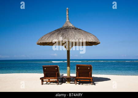Spiaggia di Mauritius con vista sull Oceano Indiano con due lettini e ombrellone shade Foto Stock
