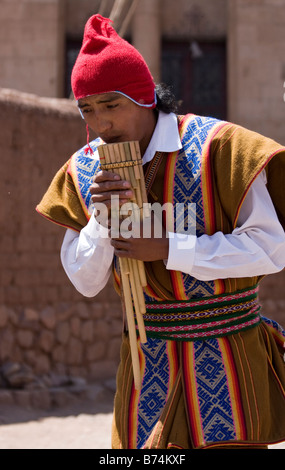 Uomo peruviano giocando zampona tradizionali tubi durante un festival inca di Pisac, Perù. Foto Stock