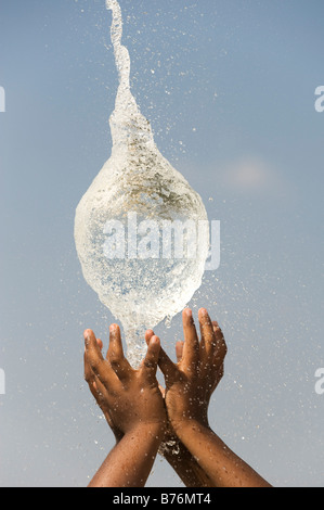 Indian boys cattura una raffica di palloncino dell'acqua. India Foto Stock