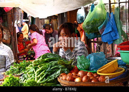 Ragazza cambogiano vendere verdure sul suo stallo a Mercato Centrale (Psar Thmei) in Phnom Penh Cambogia Foto Stock