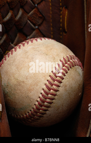 Il baseball in pelle in un guanto Foto Stock