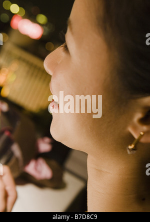 La faccia laterale della donna Foto Stock