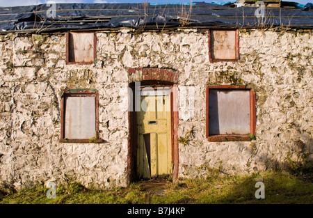 Intavolato derelitti fila di 4 terrazze cottage in pietra per la vendita mediante asta pubblica sul bordo della strada a Rhymney South Wales UK Foto Stock