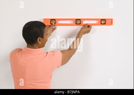 African American donna facendo Home Improvement, utilizzando un livello di spirito, Canada Columbia Britannica Foto Stock