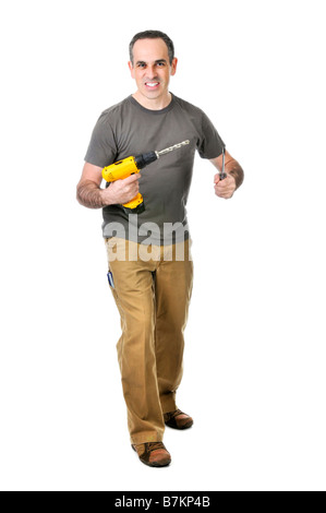 Fiducioso tuttofare tenendo un trapano e cacciavite Foto Stock