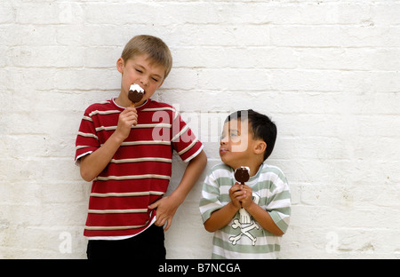 Due ragazzi mangiano gelati Foto Stock