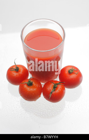 Pomodori e un bicchiere di succo di pomodoro, studio shot Foto Stock