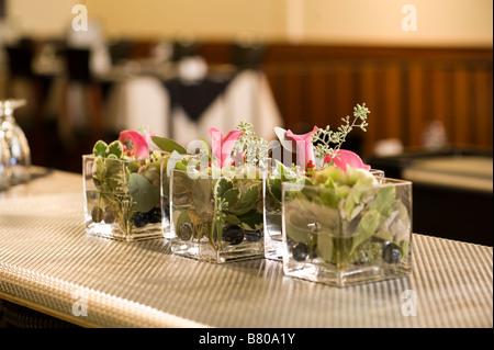 Piccoli vasi di vetro tenendo un bellissimo allestimento floreale. Foto Stock