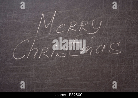 Buon Natale scritta sul banco di scuola Foto Stock