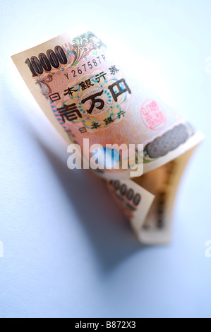 JPY 10 000 bill in un rotolo Foto Stock