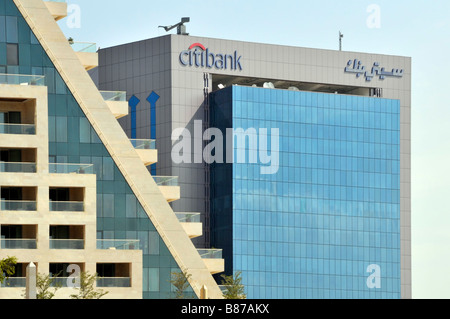 Cartelli con logo bilingue sul tetto in cima all'edificio degli uffici Citibank di Dubai con pannelli di rivestimento in vetro colorato negli Emirati Arabi Uniti in Medio Oriente Foto Stock