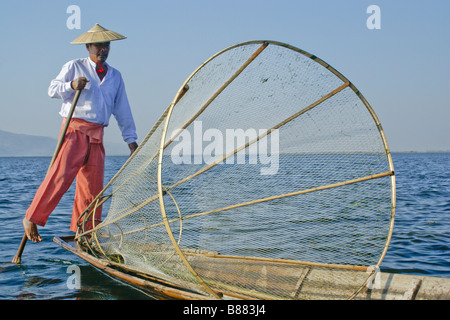 Gamba Intha-canottaggio fisherman con cestello net sul Lago Inle, Myanmar (Birmania) Foto Stock