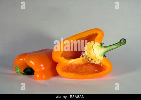 Un colore giallo o arancio il peperone tagliato a fette o intero. Foto Stock