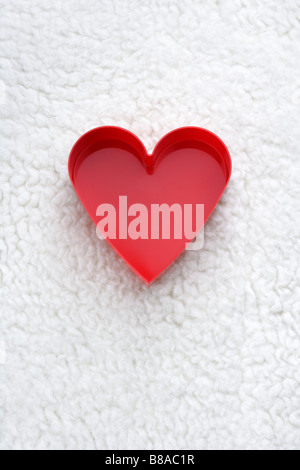Plexiglasherz auf Flokati Foto Stock