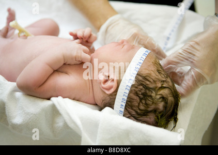 Neonato ragazzo di essere pesate misurate Foto Stock