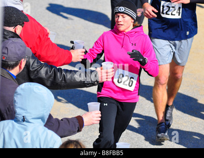 Runner in gara a stazione di acqua Foto Stock