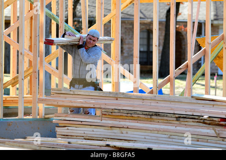 Un giovane operaio porta legname per la costruzione di nuovi alloggi. Oklahoma City, Oklahoma, Stati Uniti d'America. Foto Stock