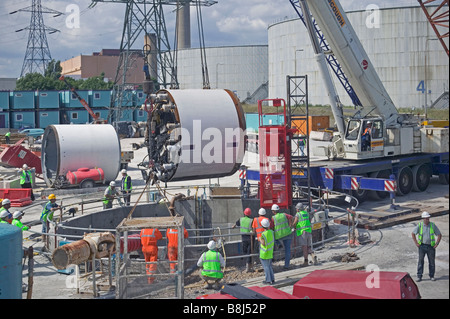 I contraenti abbassamento di una macchina di foratura di gallerie in un albero di accesso, la TBM sarà scavare un cavo di potenza in tunnel di Londra. Foto Stock