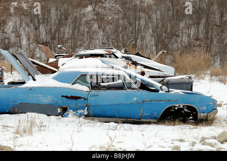 Vecchia auto in una coperta di neve junk yard Foto Stock