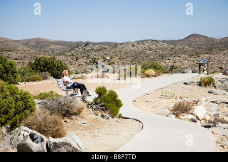 La donna prende il bagno di sole, Vista tasti, Joshua Tree National Park in California, Stati Uniti d'America Foto Stock