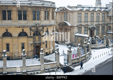 La neve copre l'imperatore statue e Sheldonian Theatre con il museo della scienza sulla destra in Oxford University Foto Stock