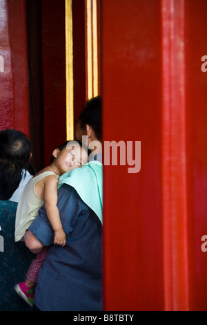 Dormire bambino cinese detenuto da suo padre nel Palazzo Imperiale, la Città Proibita di Pechino, Cina. Foto Stock