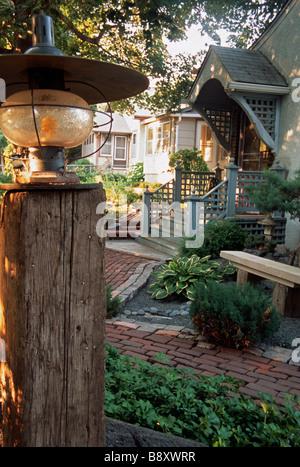 Parte anteriore di Minneapolis, Minnesota home con legno stagionato POST E LUCE, riciclato percorso di mattoni e pietra banco. L'estate. Foto Stock