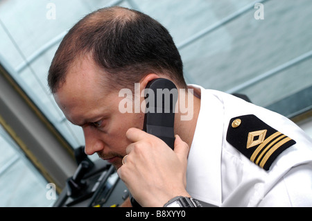 Un ufficiale della Flotta Reale ausiliari di utilizza un telefono radio sul ponte dell'onda RFA righello Foto Stock