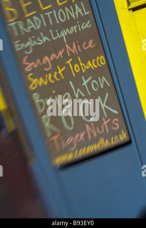 Cartello che elenca i diversi tipi di caramelle tra cui Brighton rock per la vendita al di fuori del negozio in North Laine Brighton Foto Stock