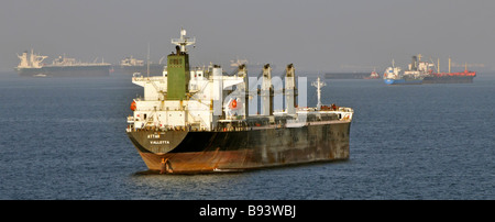 Le navi senza carico, le navi portarinfuse e le petroliere hanno gettato l'ancora dal porto di rifornimento petrolifero degli Emirati Arabi Uniti di Fujairah, Golfo dell'Oman, vicino allo stretto di Hormuz, foschia di calore distante Foto Stock