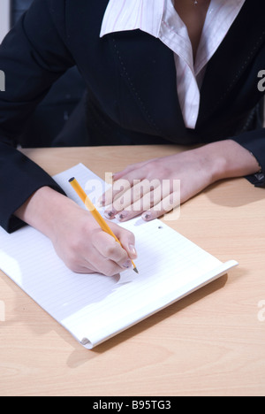 Business donna la scrittura su un blocco note Foto Stock