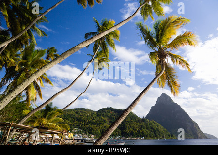 WEST INDIES Caraibi St Lucia Soufriere barche di pescatori sulla spiaggia fiancheggiato da palme di cocco. Città vulcanica e al di là di Pitons Foto Stock