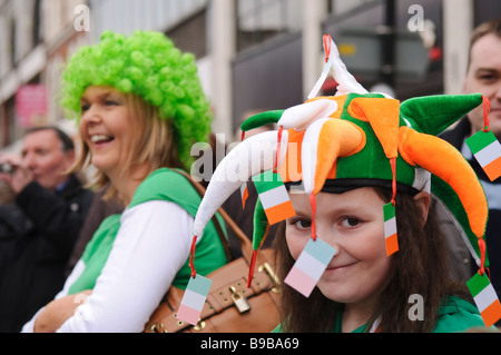 Ragazza giovane indossando jester hat in verde, bianco e arancione, i colori della bandiera irlandese, durante il giorno di San Patrizio celebrazione, Foto Stock