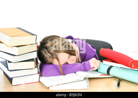 Ragazza adolescente studiando presso il desk di essere stanco Foto Stock