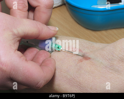 Donna con un esame di sangue prelevato Foto Stock