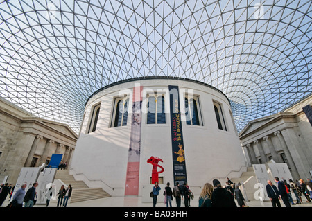 LONDRA, Regno Unito — la Queen Elizabeth II Great Court del British Museum presenta un vasto tetto in vetro e acciaio progettato da Foster and Partners, che copre circa 7.000 metri quadrati e la rende la più grande piazza pubblica coperta d'Europa quando è stata inaugurata nel 2000. Lo spazio funge da fulcro centrale del museo, con la circolare ex British Library Reading Room al suo centro. Gli striscioni della mostra visibili in questa immagine pubblicizzano "Shah Abbas: The Remaking of Iran", che si è svolto da febbraio a giugno 2009, collocando la fotografia nei primi mesi di quell'anno. Foto Stock